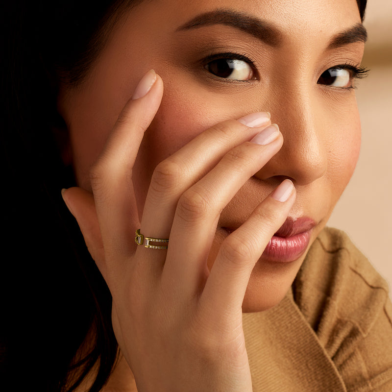 14kt yellow gold diamond open-space ring on finger with small baguette stones