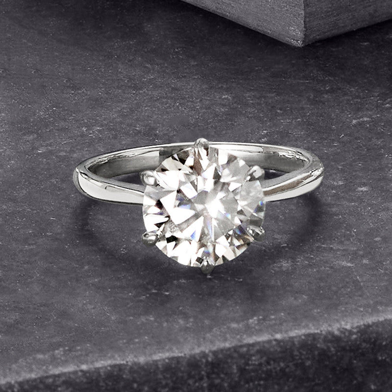 Sterling silver solitaire ring with round moissanite center, angled top view