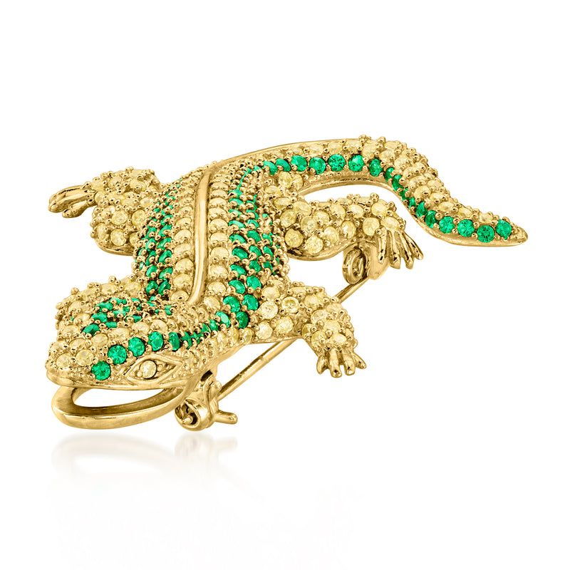 Gold-tone lizard pin with green round stones, detailed head and raised tail