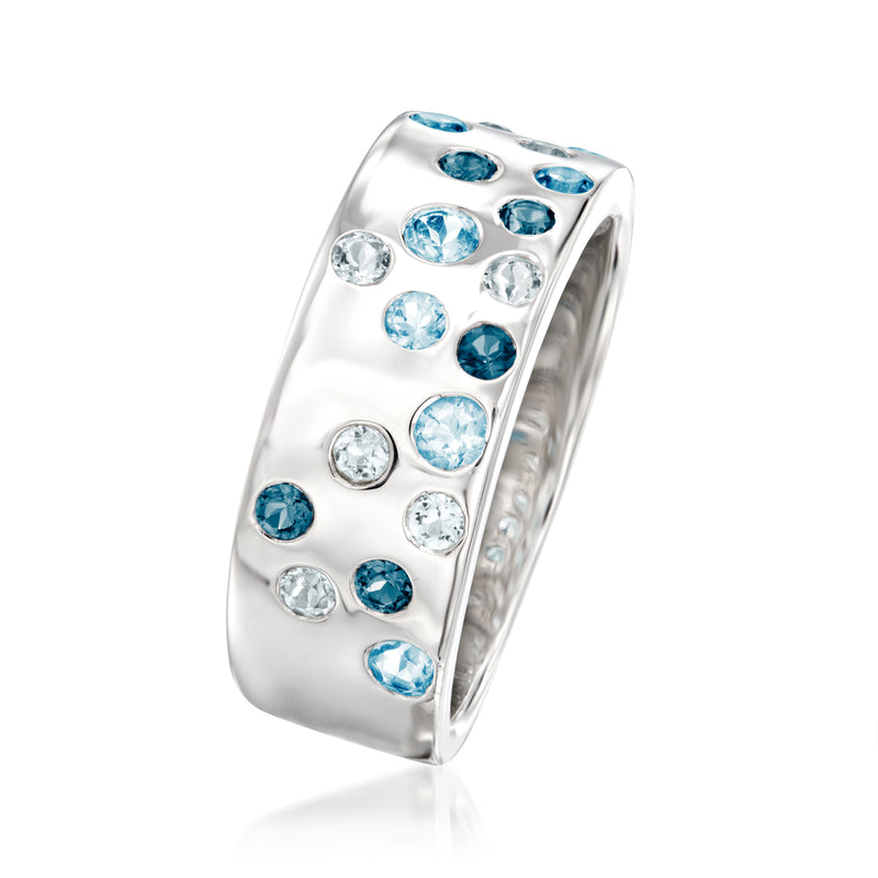 Sterling silver ring with blue topaz and clear round stones, angled side view