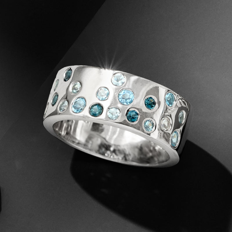 Sterling silver ring with blue topaz mosaic of round stones, tilted top view