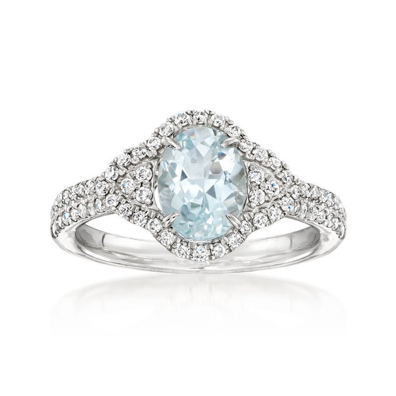 Aquamarine and diamond ring in 14kt white gold with oval center stone and halo