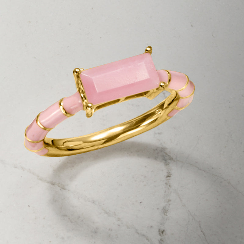 Side view of gold-tone pink enamel ring with rectangular pink opal centerpiece