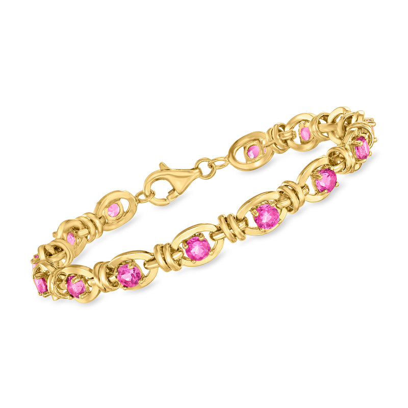 Gold-tone oval-link bracelet with round and oval pink gemstones, bright pink sparkle accents