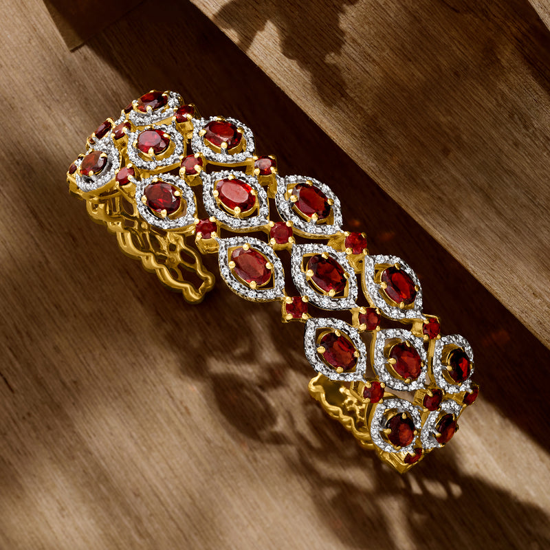 Gold over sterling bracelet with alternating oval garnets and white zircon borders, side view