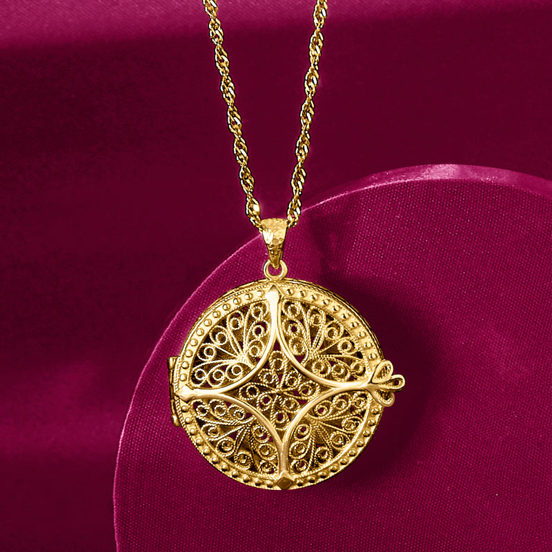 Round gold-tone filigree locket pendant with bail on a fine chain