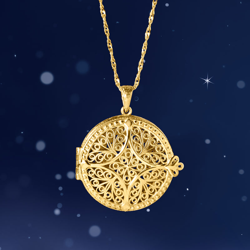 Gold-tone round filigree locket pendant with small side pin on chain