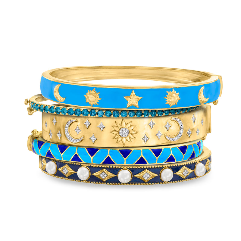Set of five gold-tone bangle bracelets with blue enamel and star, moon, sun charms