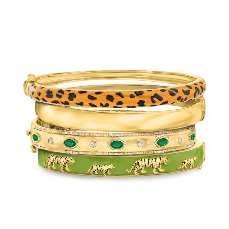 Set of four gold bangles with leopard print, green enamel and crystal studs