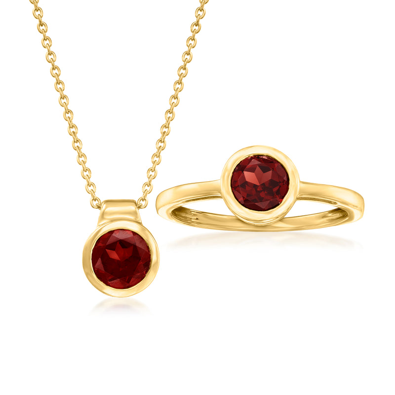 Gold-tone garnet pendant necklace with round red gemstone and matching ring