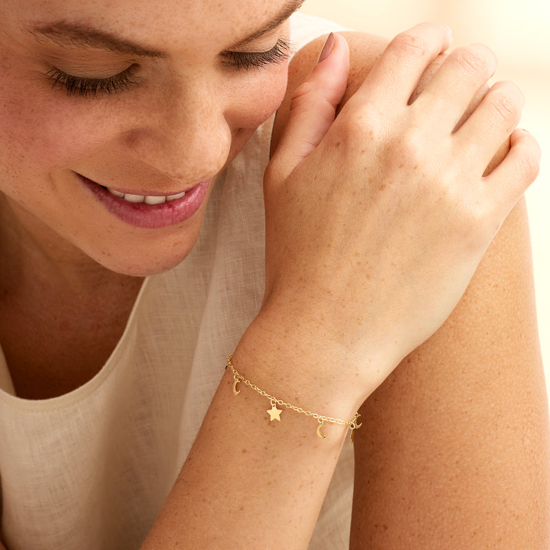 14kt yellow gold moon and stars bracelet worn on wrist with small star charm