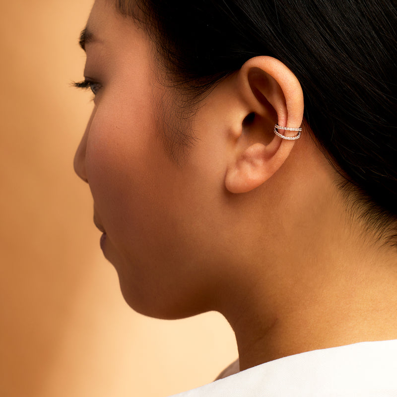 Sterling silver diamond two-row ear cuff worn on ear
