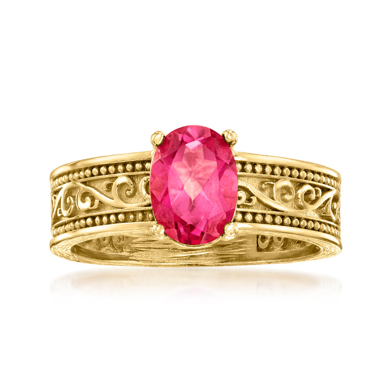 Gold scrollwork ring with oval pink gemstone centerpiece