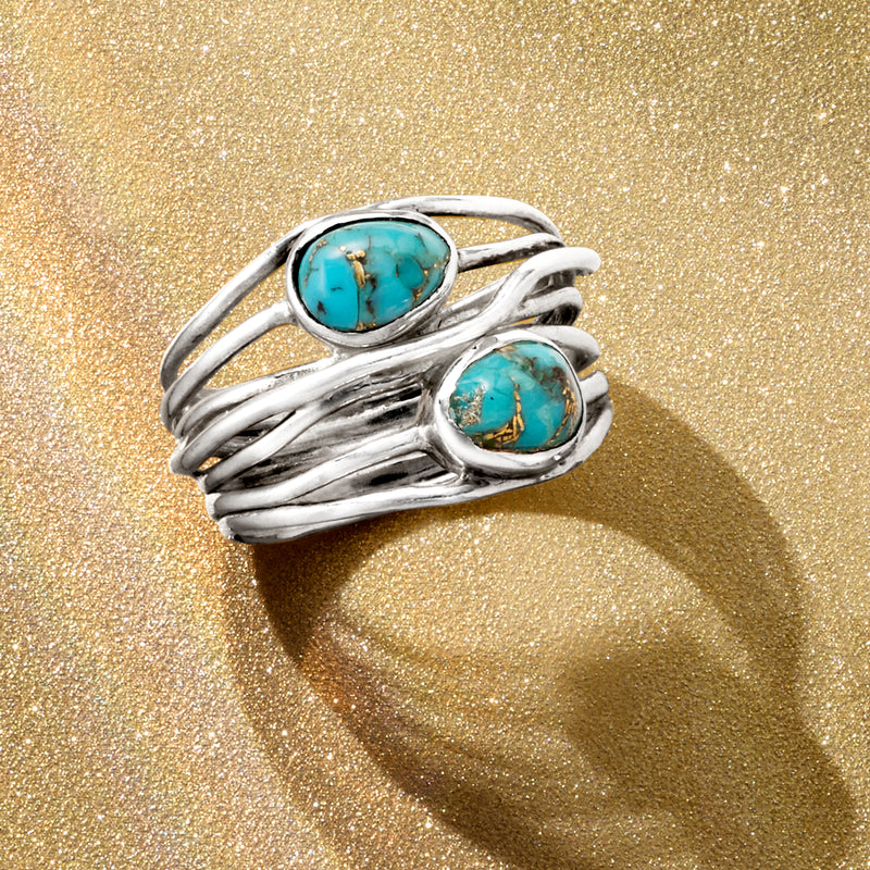 Sterling silver wrap ring featuring two oval turquoise cabochons with curved braided shanks