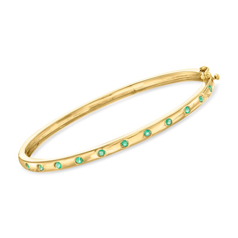 Gold over sterling bangle bracelet with small round green gemstones along the band