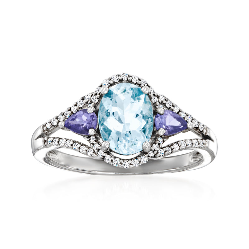 Sterling silver ring with oval aquamarine center, purple gemstone side stones, diamond halo.
