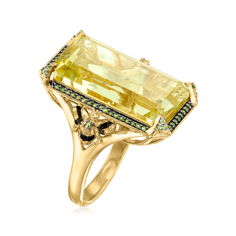 Gold ring angled view: lemon-yellow rectangular stone with green border and black enamel setting