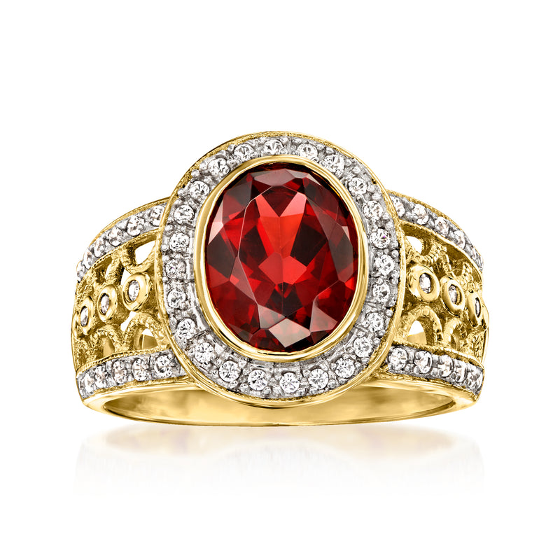 Oval red garnet ring with white zircon halo and filigree in gold over sterling
