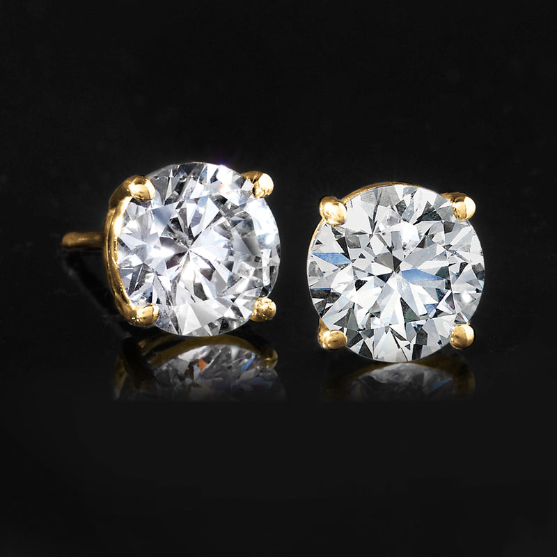 Round lab-grown diamond stud earrings in 14kt yellow gold, close-up on raised prongs
