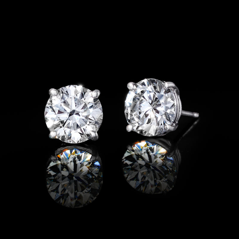 Round diamond stud earrings in 14kt white gold, post backs visible