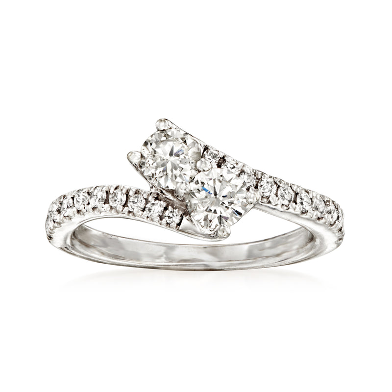 Vintage bypass diamond ring in 14kt white gold with round center stone and pave sides
