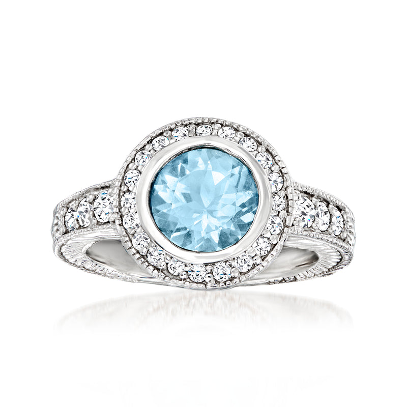 14kt white gold halo ring with oval aquamarine center and diamond pave accents