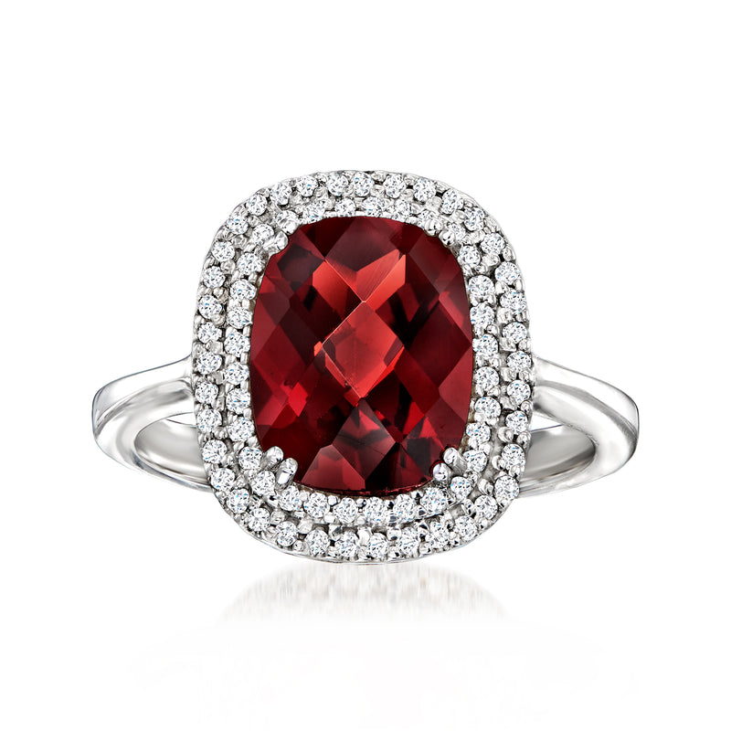 White gold garnet halo ring with oval red gemstone and round diamond side accents