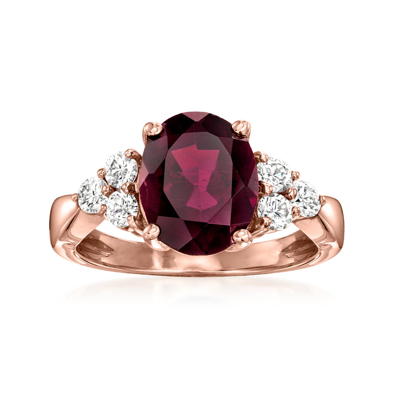 14kt rose gold ring with oval rhodolite garnet and diamond halo