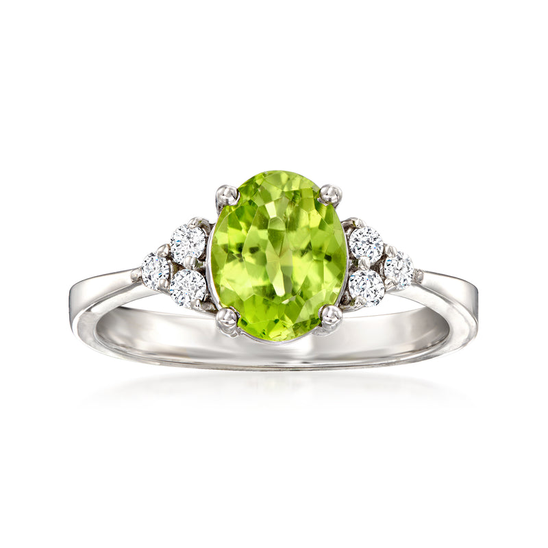 14kt white gold ring with oval green peridot center, round diamond halo, diamond shoulders