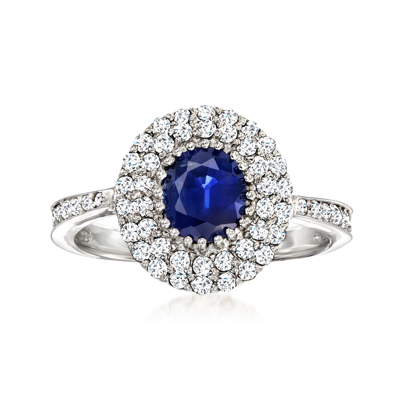 14kt white gold ring with round dark-blue sapphire and diamond halo, prong-set