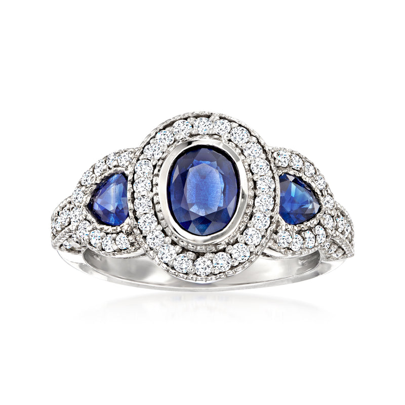 14kt white gold ring with oval blue sapphire, diamond halo and three side diamonds