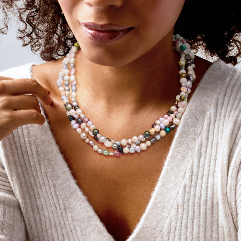 Multicolored cultured pearl torsade necklace worn at the neckline