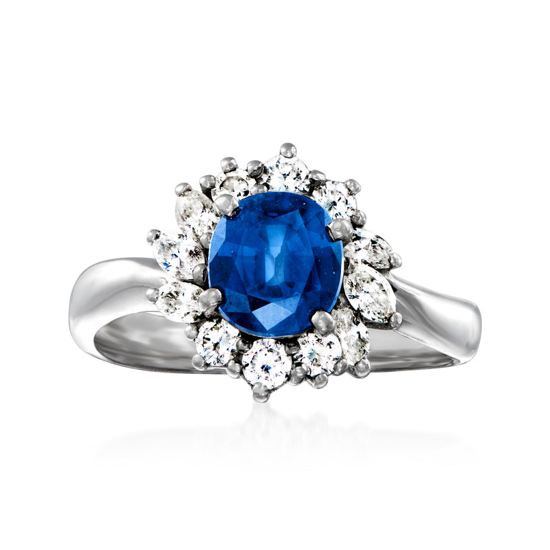 Platinum ring with oval blue sapphire center and round diamond halo