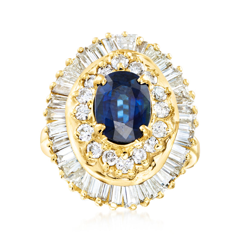 Oval blue sapphire ring with diamond halo and baguette side stones in 14kt yellow gold