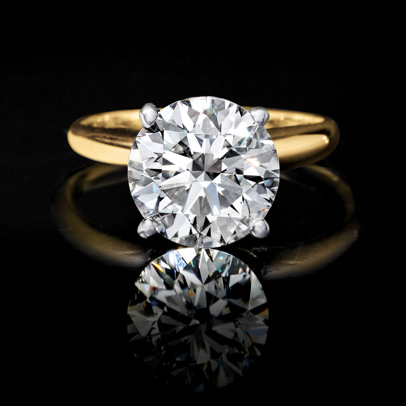 14kt yellow gold solitaire diamond ring with large round center stone and four prongs