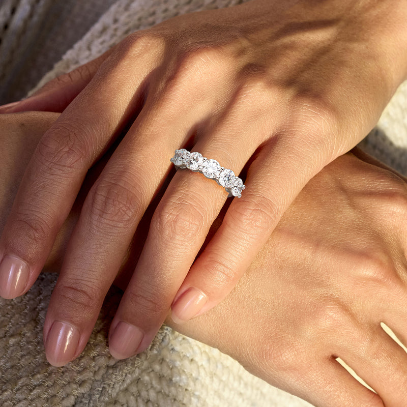 14kt white gold five-stone diamond ring on hand with five round diamonds