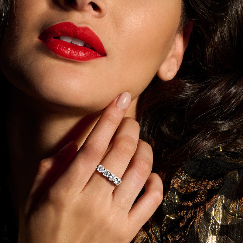 Five-stone diamond ring in 14kt yellow gold, small round stones, close-up on finger