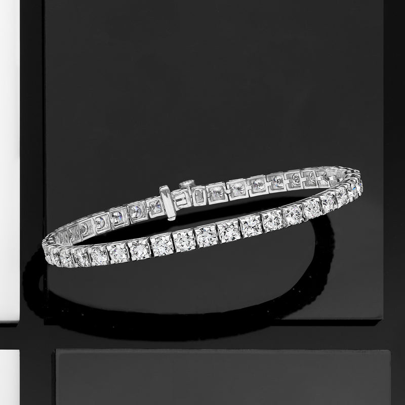 Diamond tennis bracelet with round-cut stones and box clasp, angled view