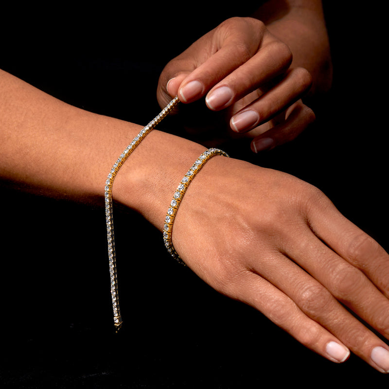 14kt yellow gold tennis bracelet with round diamonds on hand