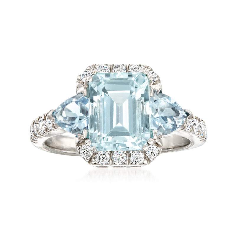 14k white gold ring with emerald-cut aquamarine center and diamond halo accents