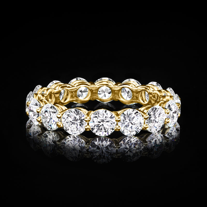 Yellow gold diamond eternity band with bright round stones in a polished setting