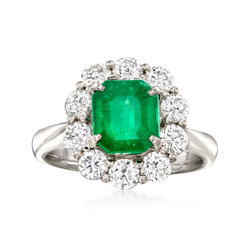 Platinum ring with emerald-cut green emerald center and diamond halo