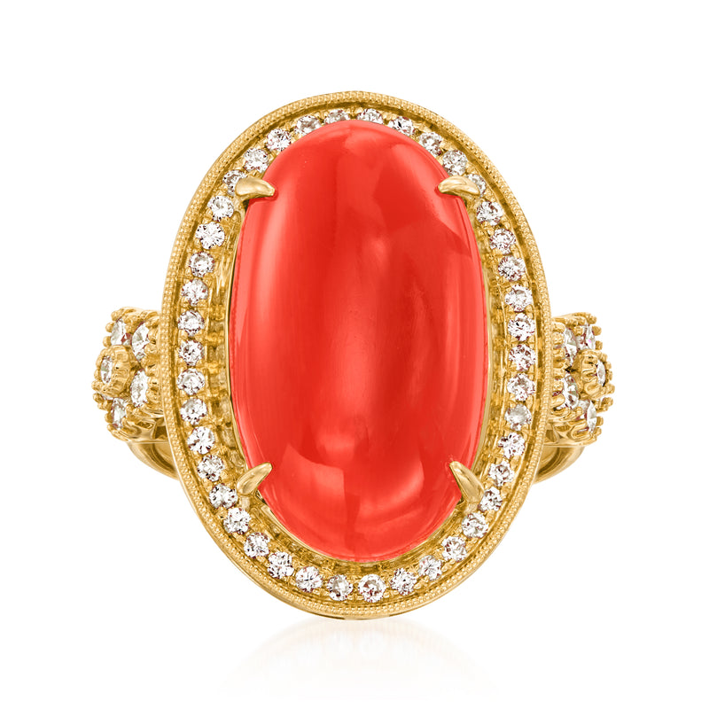 Oval red coral cabochon cocktail ring with diamond halo and yellow gold diamond shoulders