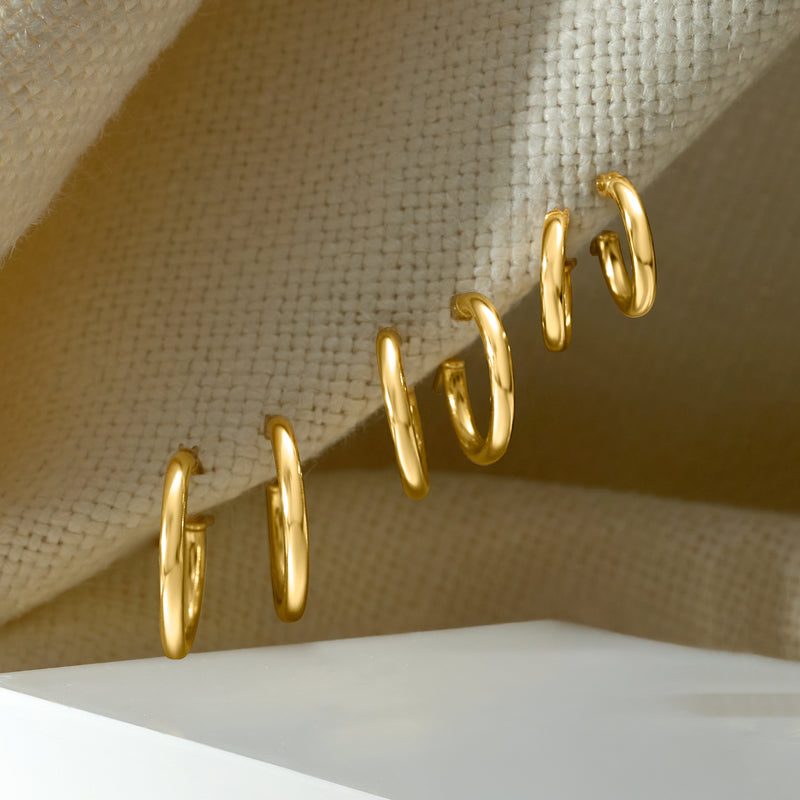 Gold small hoop earrings, hinged hoops shown from the side