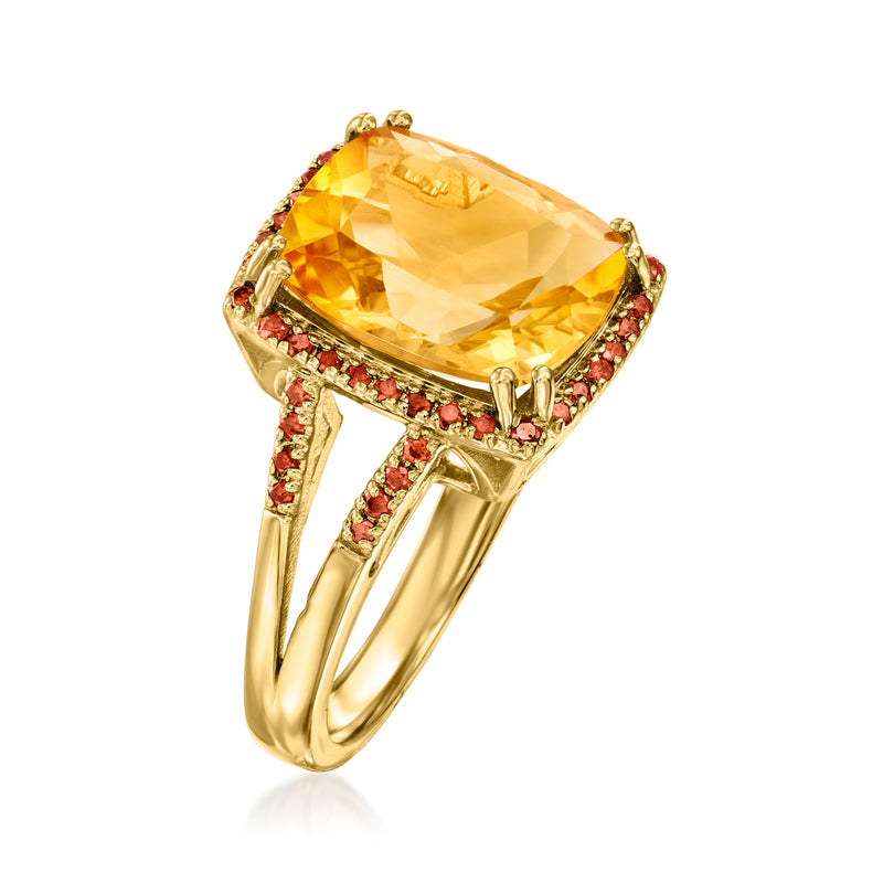 Gold oval citrine ring with red side stones, angled view, prong-set