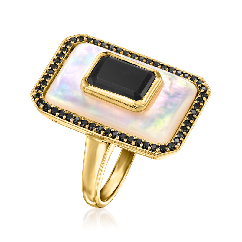 Gold ring with square mother-of-pearl panel and dark center gemstone, angled side view