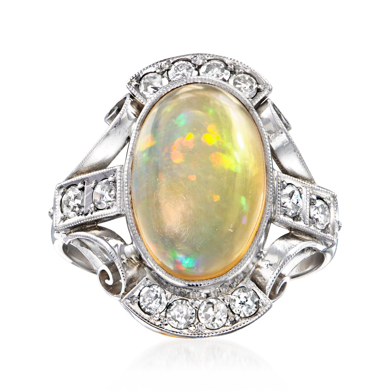 Platinum oval fire opal and diamond filigree ring with halo of round stones