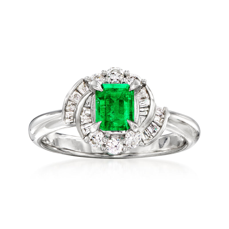 Platinum ring with emerald-cut green emerald center, surrounded by diamond halo and side stones