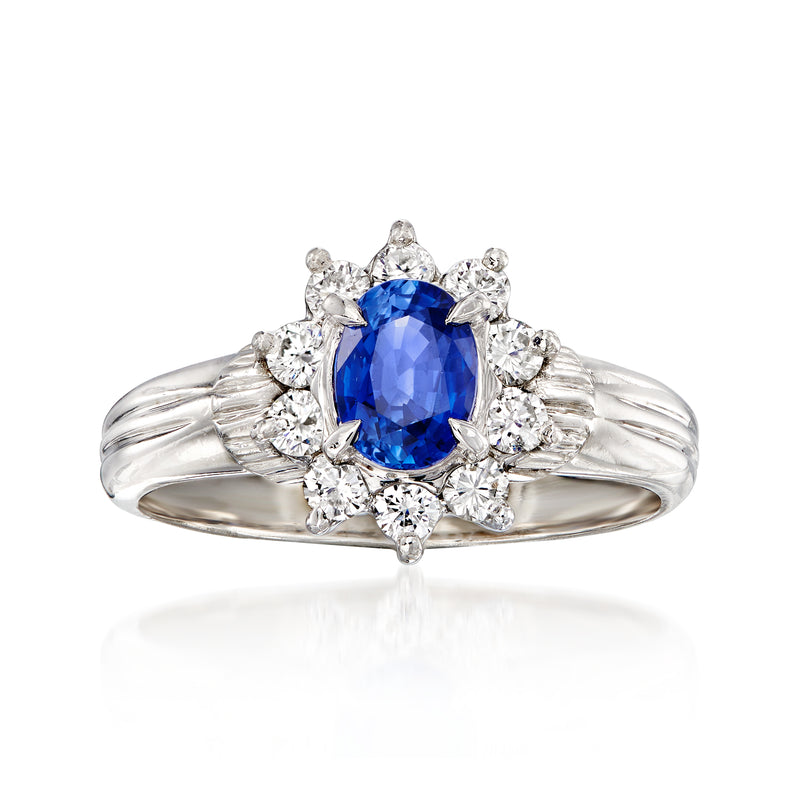 Vintage platinum sapphire and diamond ring, oval blue center with diamond halo
