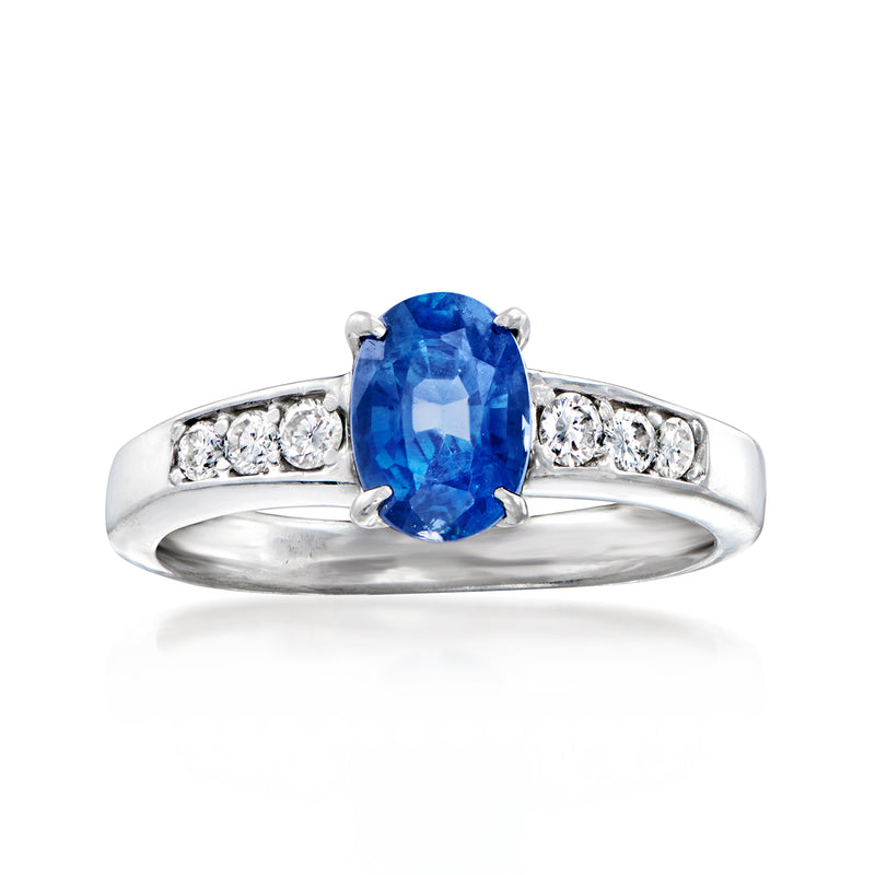 Vintage sapphire and diamond ring with oval blue gemstone in platinum setting